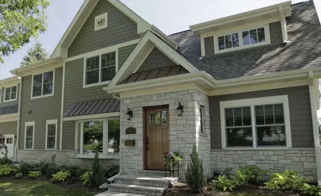 A residence with gray siding and brown trim, highlighting a contemporary architectural style.