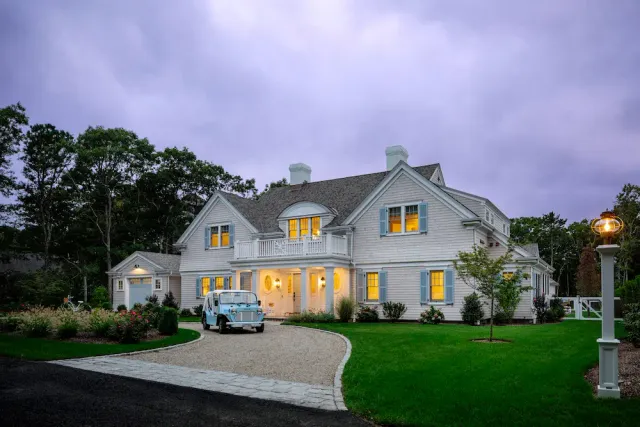 Large private home with a front balcony and blue shutters