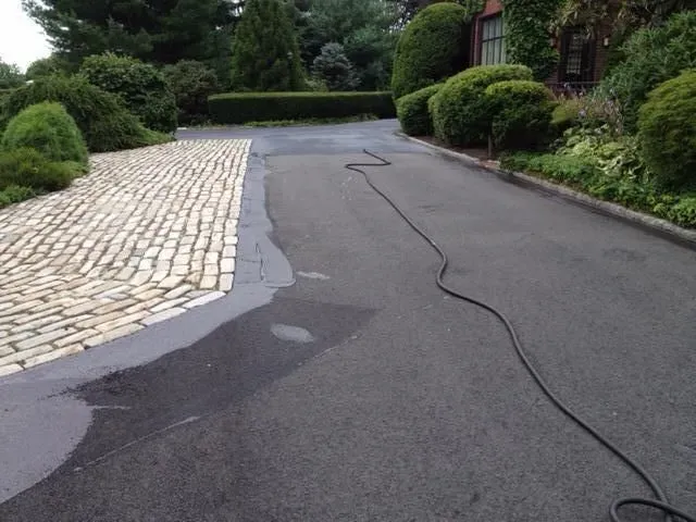 A hose is attached to the side of a road