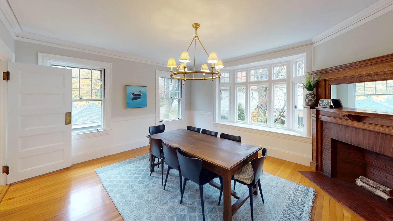 Dining room with bay window and original oak mantel
