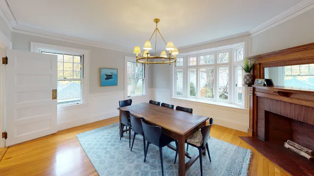 Dining room with bay window and original oak mantel