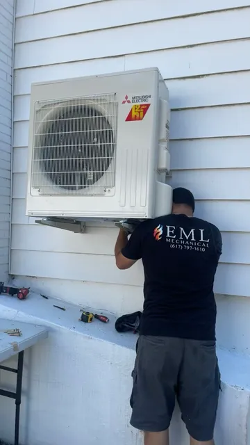 EML Mechanical technician installing a Mitsubishi ductless heat pump