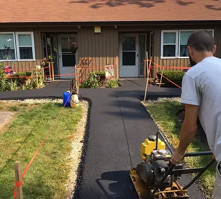 GSM employee paving a new walkway for a house