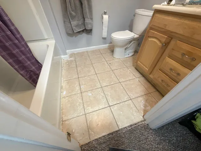 Bathroom tile floor before the Providence flooring project