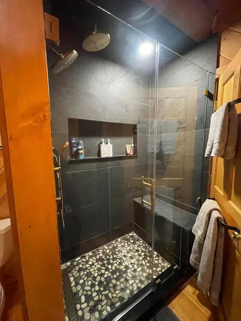 Modern glass-enclosed shower with tile walls — deep cleaning service Raymond Sebago Lake area