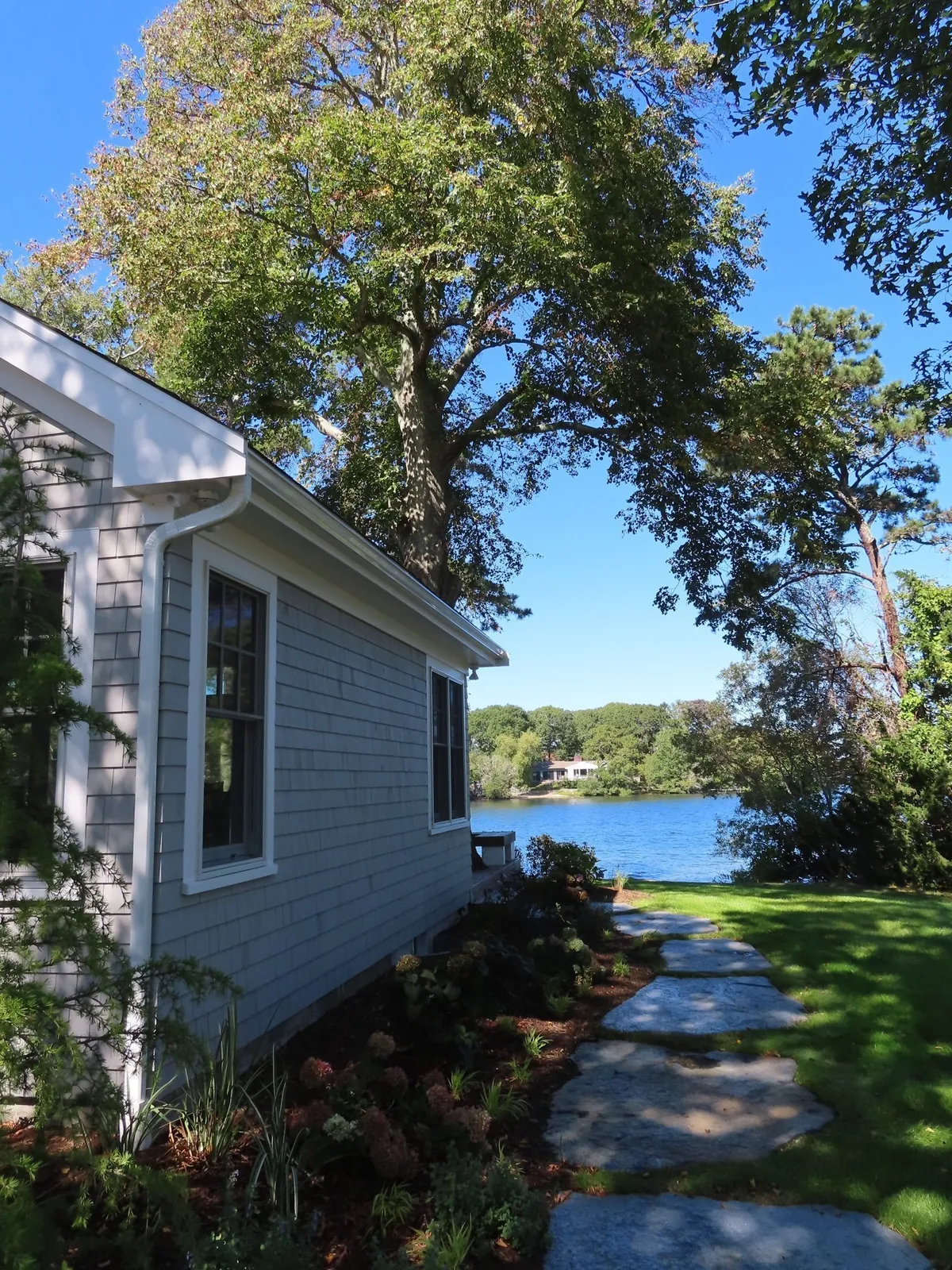 An addition on a house with a walkway to the water views on Cape Cod