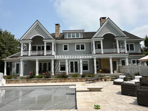 Outside of historical home with white pillars and grey exterior