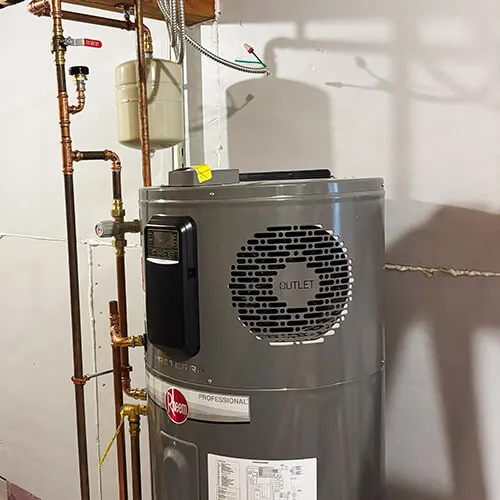 Gray Rheem professional water heater with connected copper pipes and pressure gauge in a basement setting.