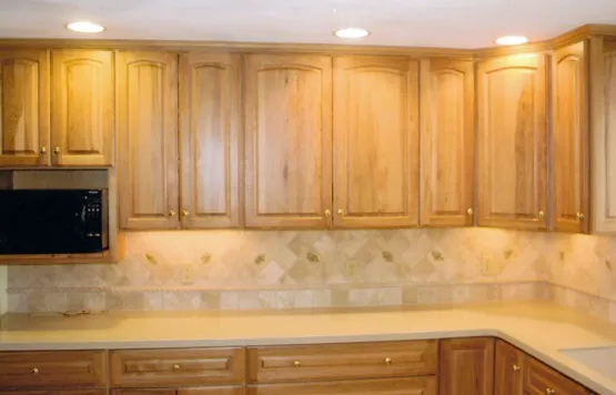 Kitchen remodel with raised-panel cherry cabinets and stone backsplash