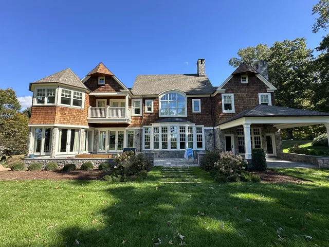 Cleaned cedar shake siding on a large home after exterior soft washing