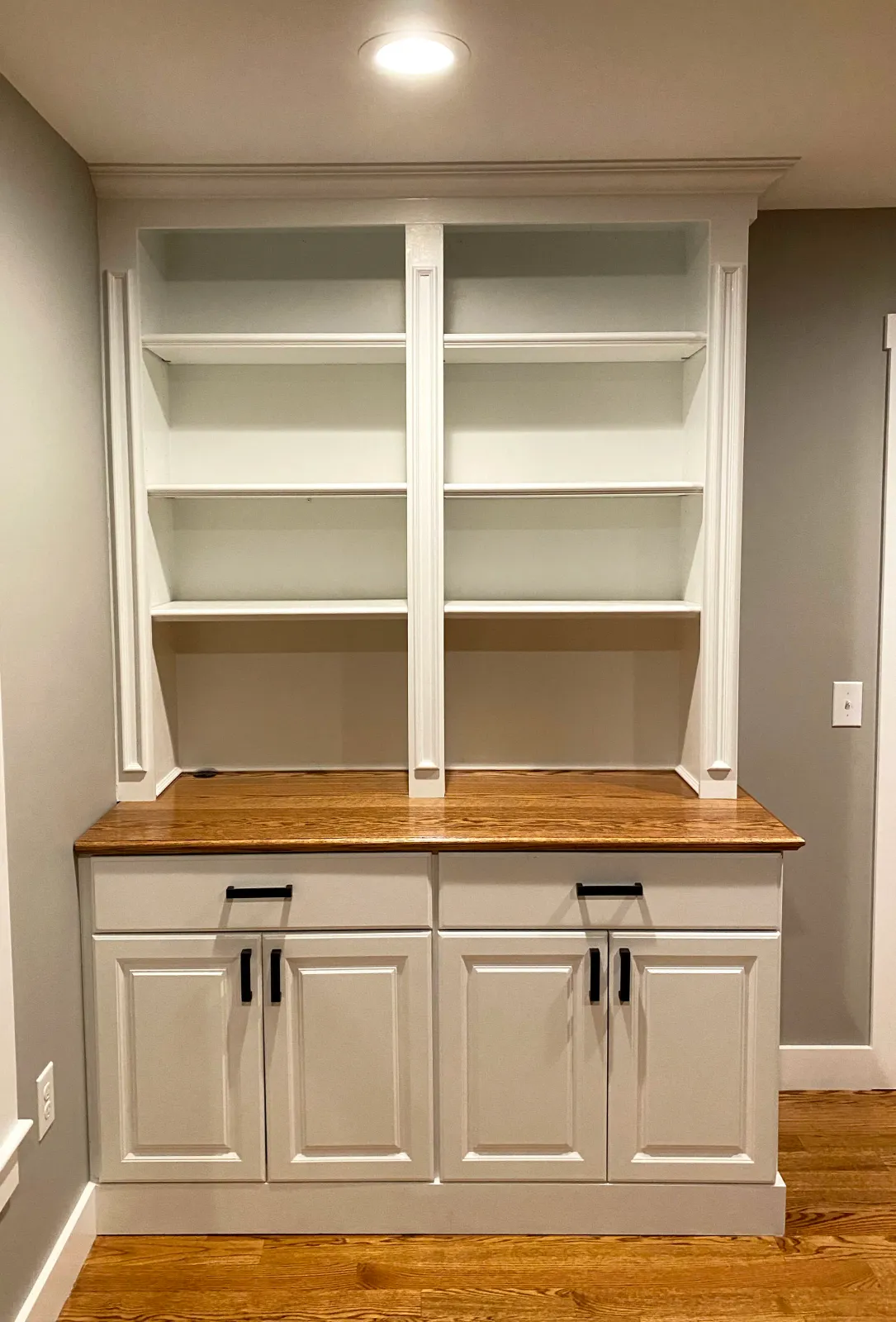 Custom cabinets and shelving, including an oak top finished to exactly match the client's floor