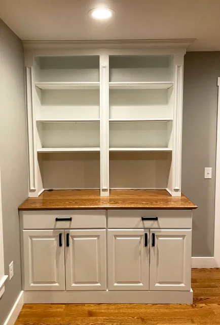 Custom cabinets and shelving, including an oak top finished to exactly match the client's floor