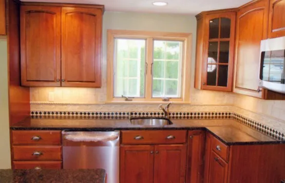 Cherry kitchen with glass upper cabinets and curved counter