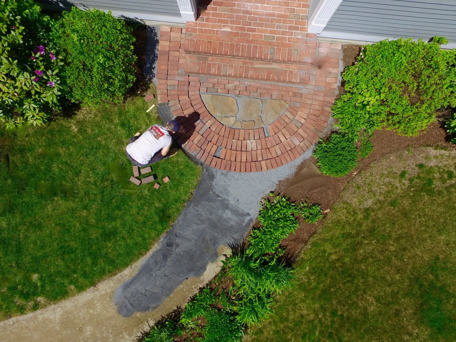 An old brick walkway was meticulously restored when its original bed had become uneven and unsafe.